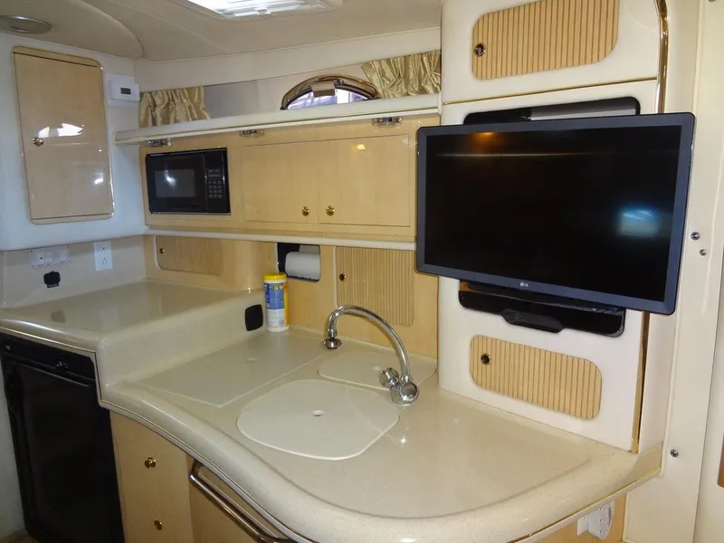 Slide: The Image of Interior of 2000 Sea Ray 340 Sundancer with kitchenette, TV, and microwave. - 33