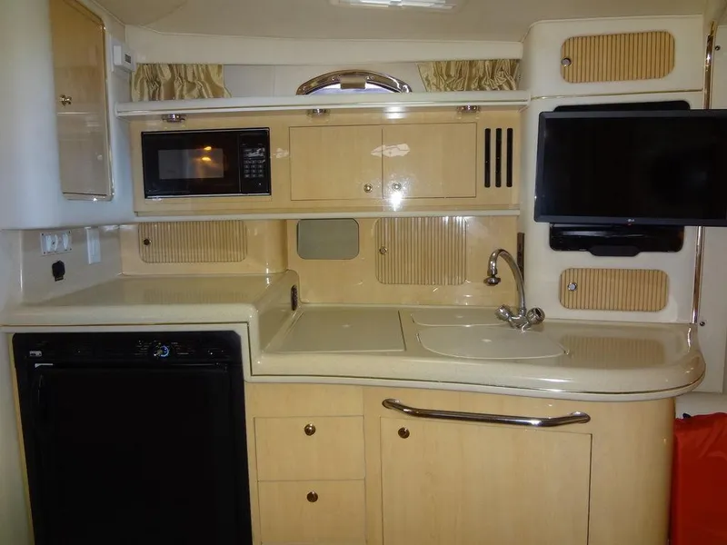 Slide: The Image of Interior of 2000 Sea Ray 340 Sundancer yacht kitchen with microwave and sink. - 34
