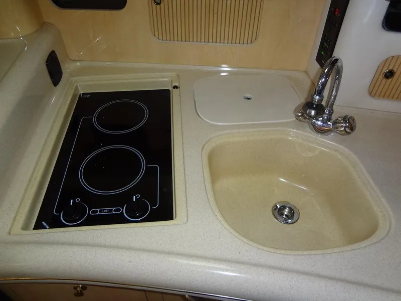 Slide: The Image of 2000 Sea Ray 340 Sundancer kitchen with stove and sink. - 35
