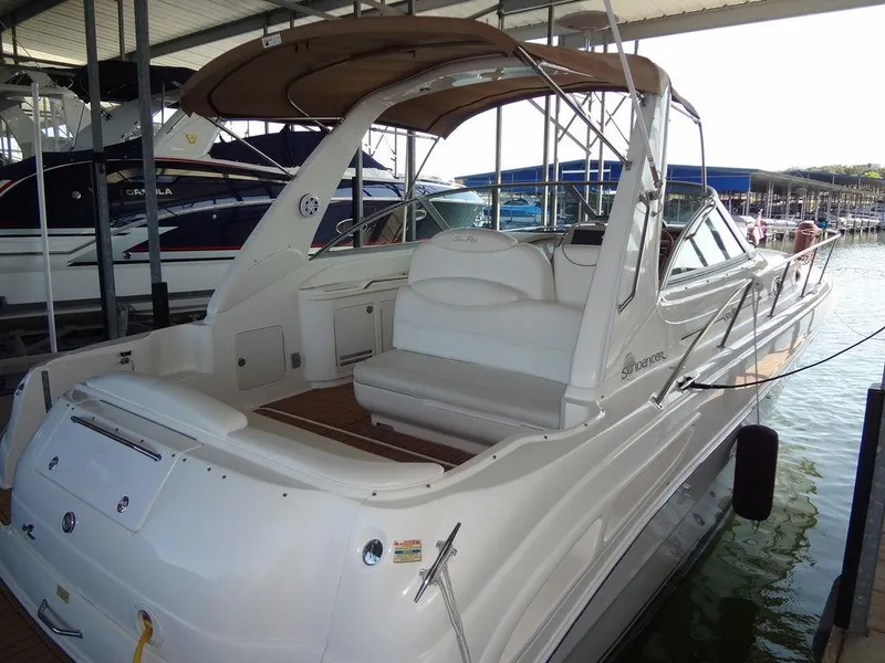 Slide: The Image of 2000 Sea Ray 340 Sundancer boat docked in marina, featuring spacious seating and sleek design. - 4