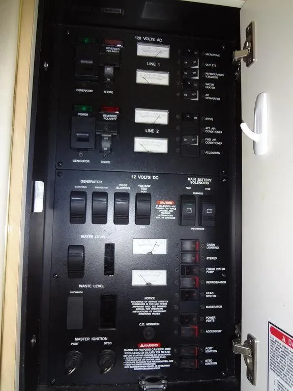Slide: The Image of Electrical panel of 2000 Sea Ray 340 Sundancer boat, showing switches and controls. - 42