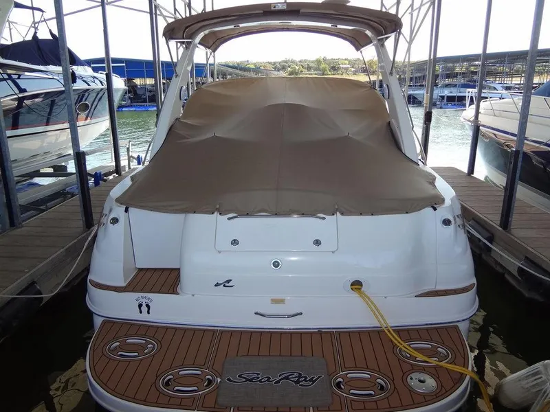 Slide: The Image of 2000 Sea Ray 340 Sundancer docked, covered, with teak swim platform. - 44