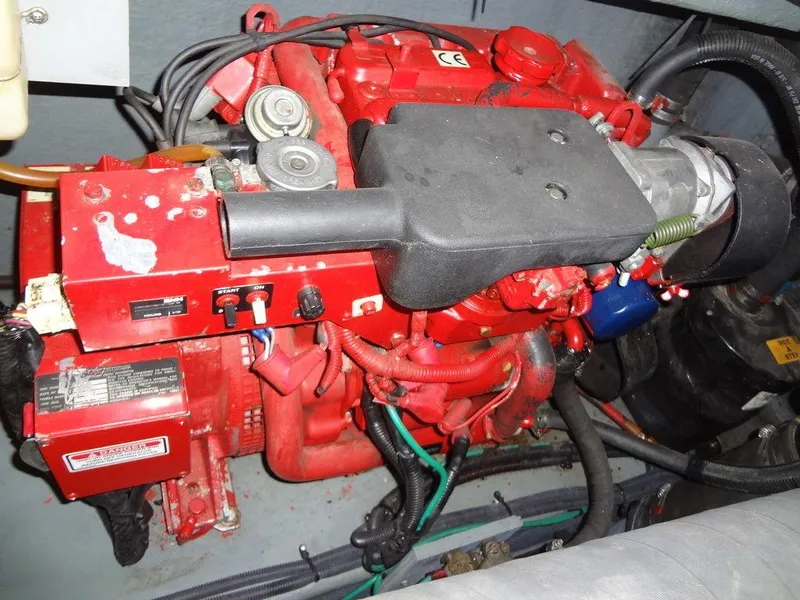 Slide: The Image of Engine of 2000 Sea Ray 340 Sundancer, featuring red components and wiring. - 48