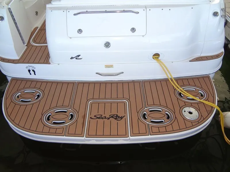 Slide: The Image of Sea Ray 340 Sundancer 2000 boat deck with wood finish and logo. - 5