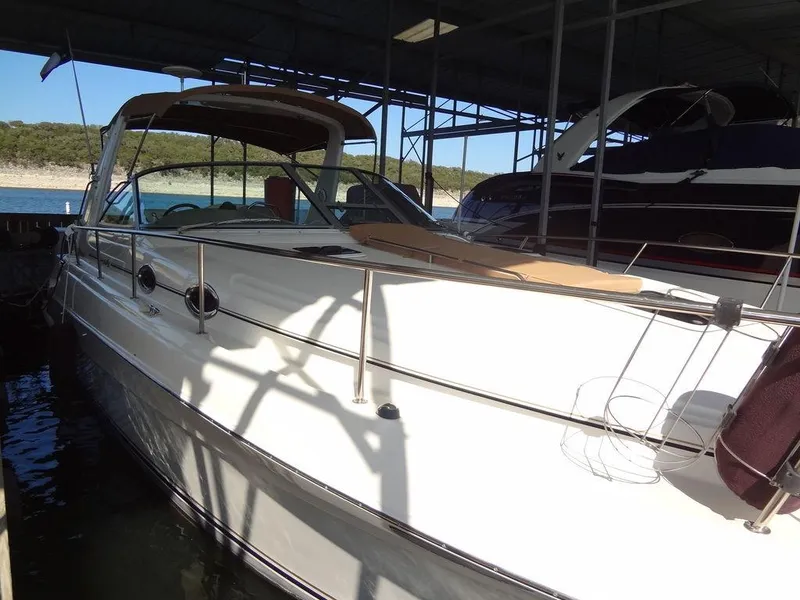 Slide: The Image of 2000 Sea Ray 340 Sundancer docked under a covered marina. - 7