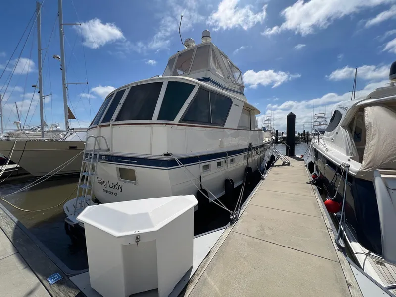The Image of 1979 Hatteras 53 Motor Yacht docked at marina under blue sky. - 0