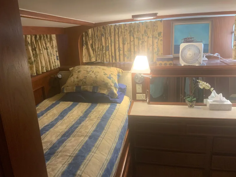Slide: The Image of Cozy cabin interior of 1979 Hatteras 53 Motor Yacht with bed and decor. - 12