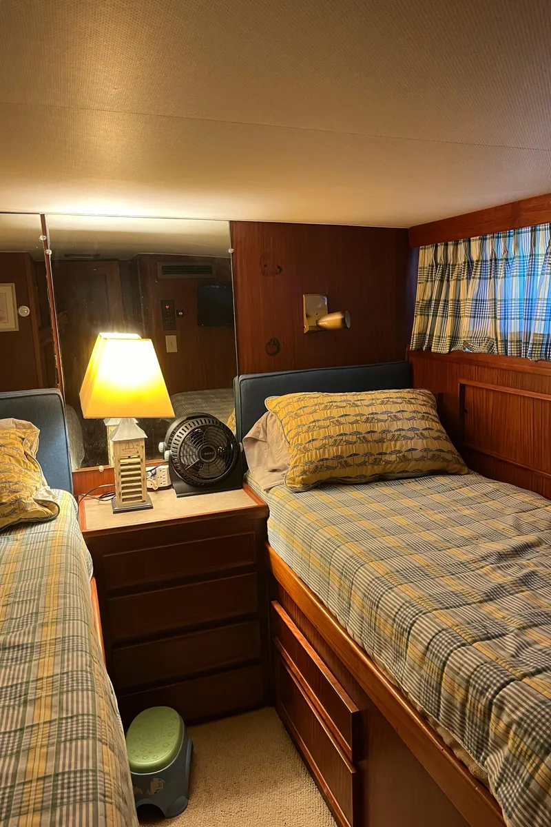 Slide: The Image of Interior of 1979 Hatteras 53 Motor Yacht with twin beds and cozy lighting. - 14