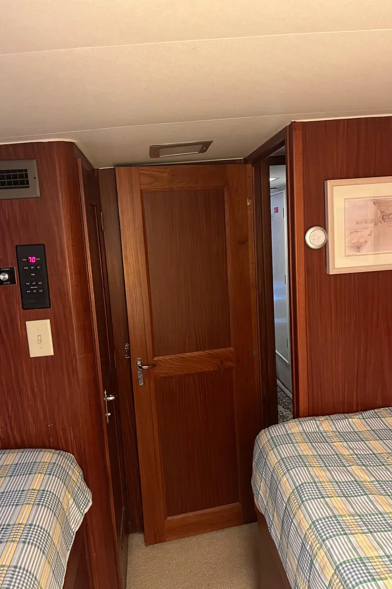 Slide: The Image of Interior cabin of 1979 Hatteras 53 Motor Yacht with twin beds and wooden door. - 15