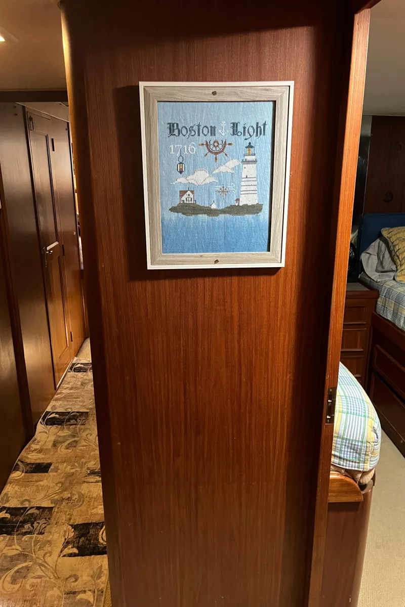 Slide: The Image of Interior of 1979 Hatteras 53 Motor Yacht with Boston Light artwork on wooden wall. - 17