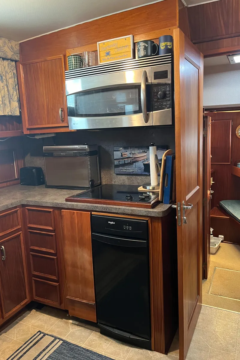 Slide: The Image of 1979 Hatteras 53 Motor Yacht kitchen with wooden cabinets and modern appliances. - 2