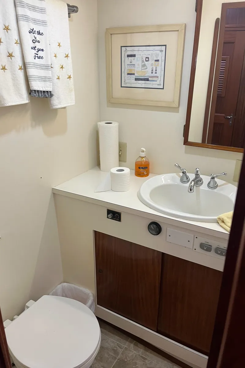 Slide: The Image of Bathroom interior of a 1979 Hatteras 53 Motor Yacht with sink and toiletries. - 24
