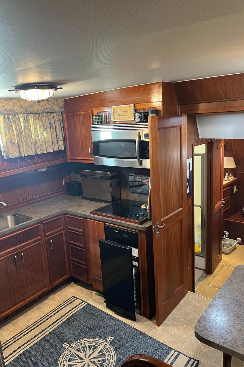 Slide: The Image of 1979 Hatteras 53 Motor Yacht kitchen with wood cabinetry and modern appliances. - 25