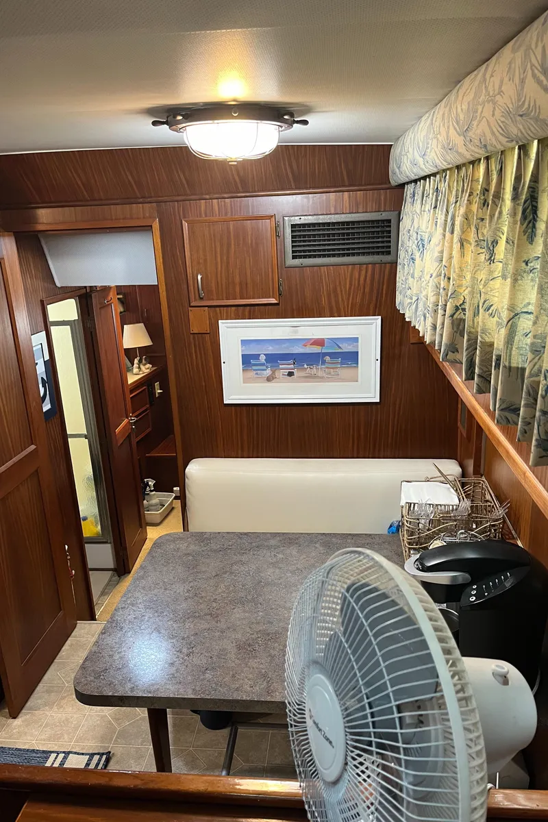 Slide: The Image of Interior of 1979 Hatteras 53 Motor Yacht with dining area and fan. - 27