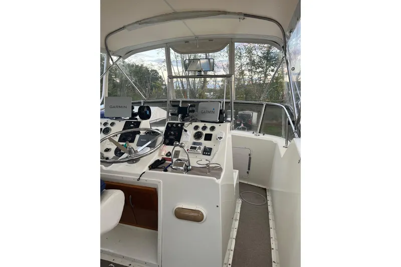 Slide: The Image of 1979 Hatteras 53 Motor Yacht helm with Garmin navigation equipment and steering wheel. - 30