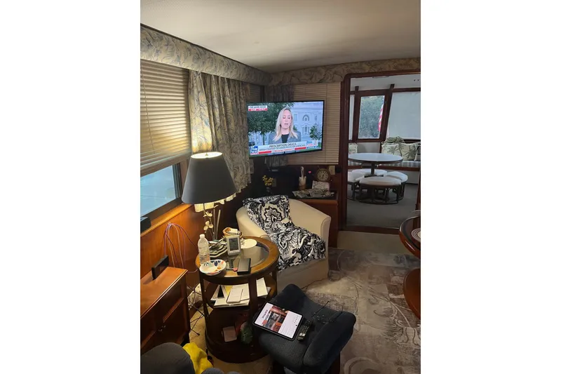 Slide: The Image of Interior of a 1979 Hatteras 53 Motor Yacht with cozy seating and a TV. - 36