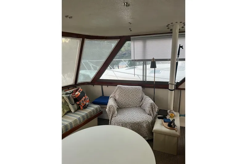 Slide: The Image of Interior of 1979 Hatteras 53 Motor Yacht with cozy seating and large windows. - 37
