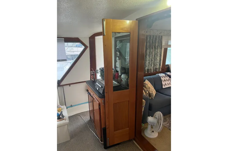 Slide: The Image of Interior of 1979 Hatteras 53 Motor Yacht with wooden cabinetry and cozy seating area. - 38