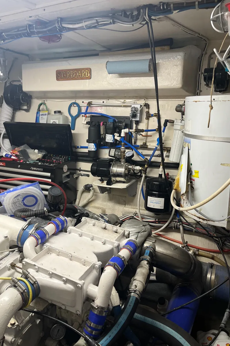 Slide: The Image of Engine room of a 1979 Hatteras 53 Motor Yacht with visible machinery and piping. - 6