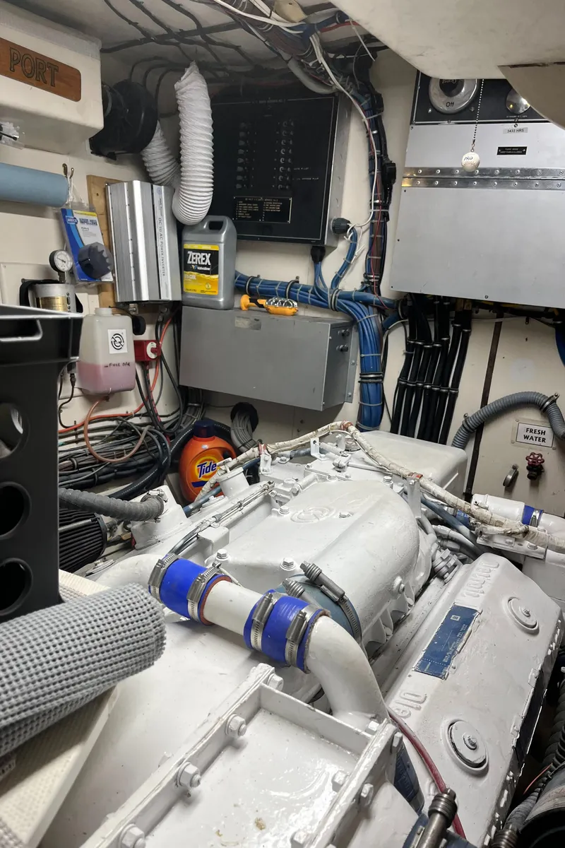 Slide: The Image of Engine room of a 1979 Hatteras 53 Motor Yacht with visible machinery and wiring. - 7