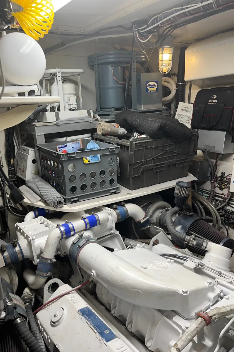 Slide: The Image of Engine room of 1979 Hatteras 53 Motor Yacht with organized storage and mechanical components. - 8