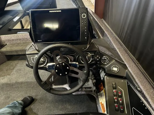 Slide: The Image of 2024 Skeeter ZXR 21 boat dashboard with steering wheel and Humminbird display. - 14