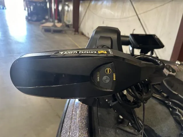 Slide: The Image of Close-up of a 2024 Skeeter ZXR 21 boat's trolling motor in a warehouse setting. - 8