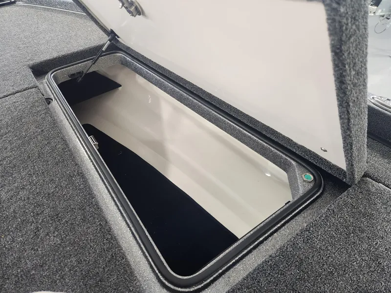 Slide: The Image of 2025 Ranger Z520R Garmin storage compartment with open lid, showcasing spacious interior. - 11