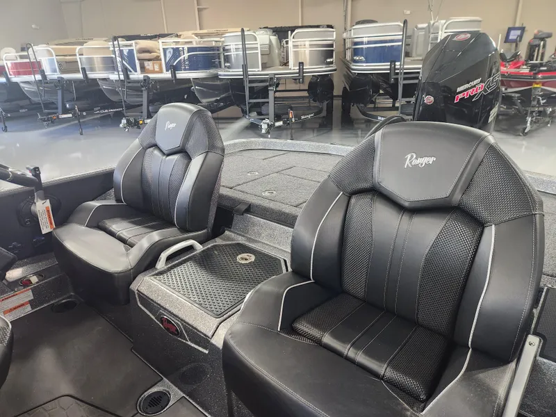 Slide: The Image of 2025 Ranger Z520R Garmin Ranger Cup boat interior with black leather seats. - 17