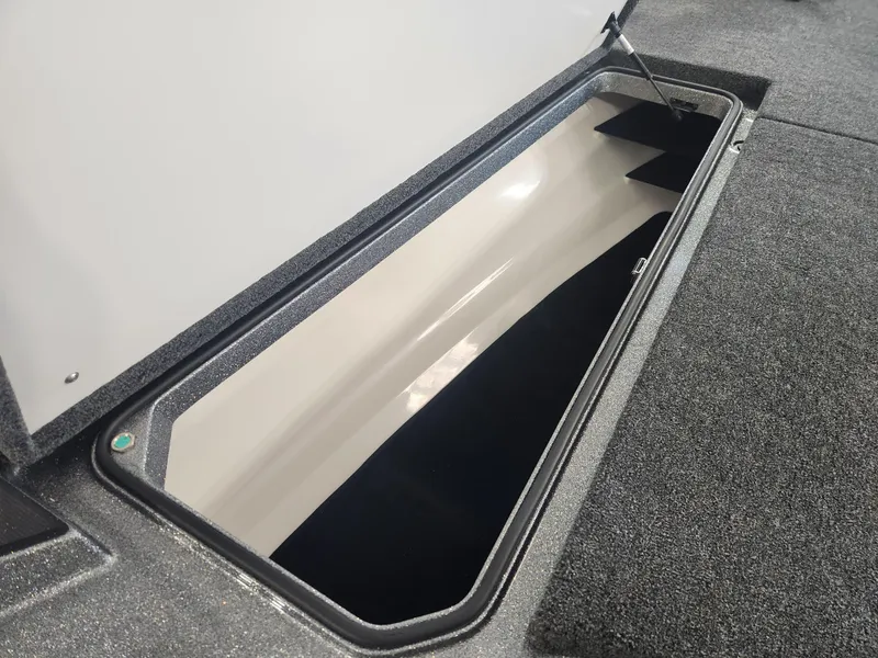 Slide: The Image of 2025 Ranger Z520R Garmin storage compartment, open lid, spacious interior, sleek design. - 9