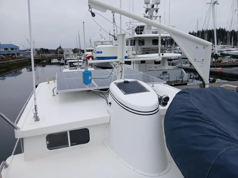Slide: The Image of 2007 Nordic Tug 37 with solar panels docked in a marina. - 10
