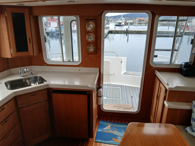Slide: The Image of Interior of 2007 Nordic Tug 37 with kitchen and marina view through windows. - 20