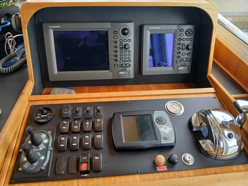 Slide: The Image of Control panel of a 2007 Nordic Tug 37 with navigation screens and controls. - 23