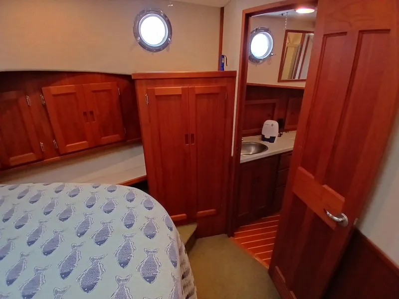 Slide: The Image of Cozy cabin interior of 2007 Nordic Tug 37 with wooden cabinetry and nautical decor. - 28
