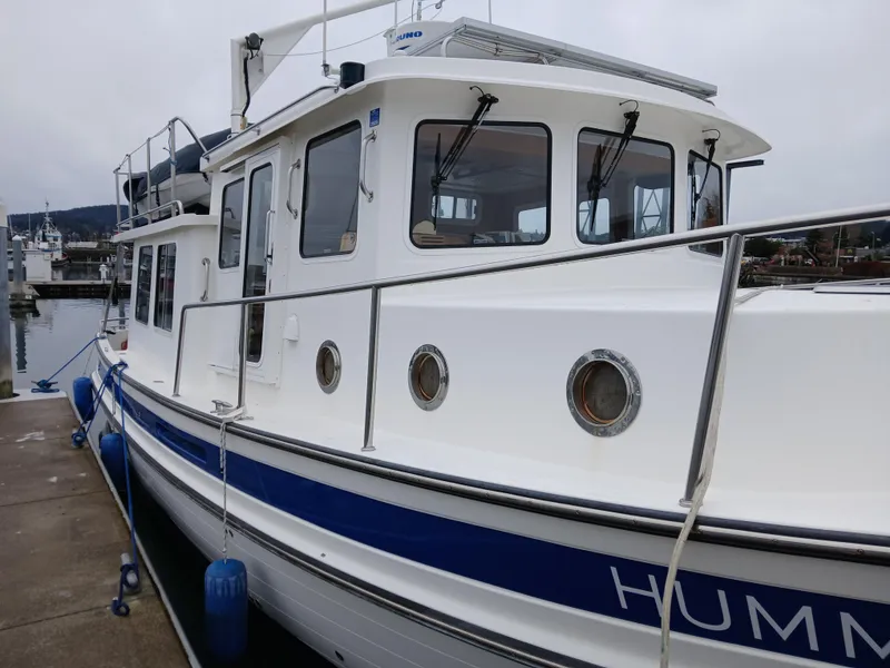 Slide: The Image of 2007 Nordic Tug 37 docked, showcasing its classic design and sturdy build. - 3
