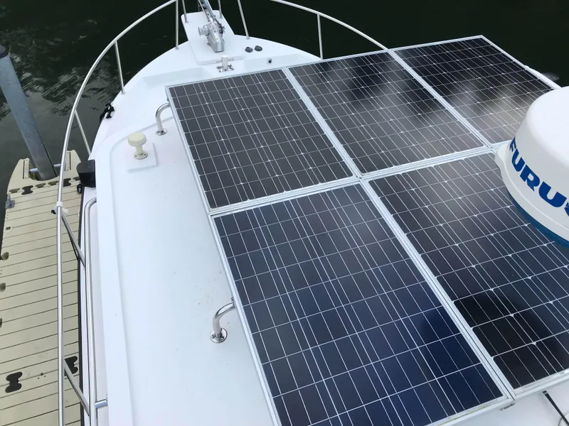 Slide: The Image of Nordic Tug 37 (2007) with solar panels on deck, docked at marina. - 4