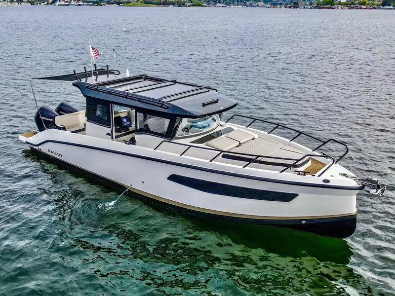 Slide: The Image of 2025 Navan C30 boat cruising on a calm lake with scenic background. - 0