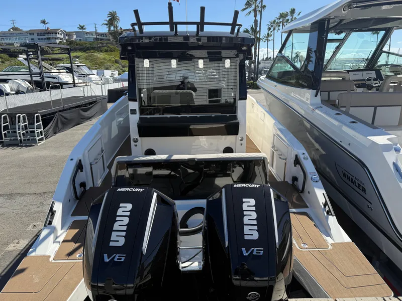 Slide: The Image of Navan C30 2025 boat with dual Mercury 225 V6 engines docked at a marina. - 10