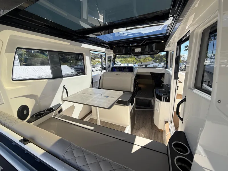 Slide: The Image of 2025 Navan C30 boat interior with seating, table, and modern design. - 14