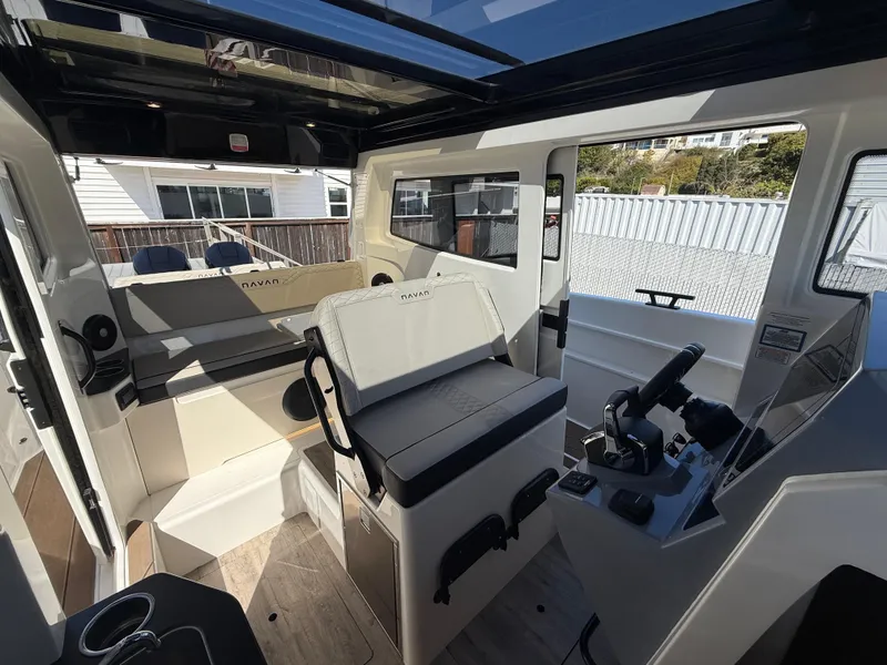Slide: The Image of Interior of 2025 Navan C30 boat, featuring modern seating and control panel. - 16