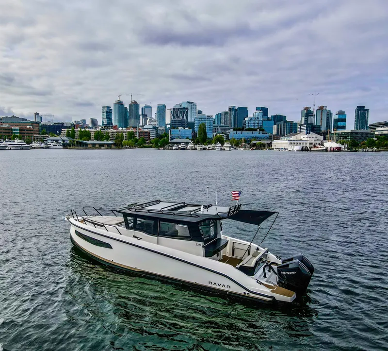 Slide: The Image of Navan C30 boat on water with city skyline in background, 2025 model. - 21