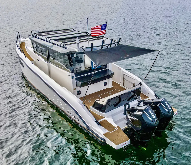 Slide: The Image of 2025 Navan C30 boat with dual Mercury engines on water, featuring an American flag. - 4