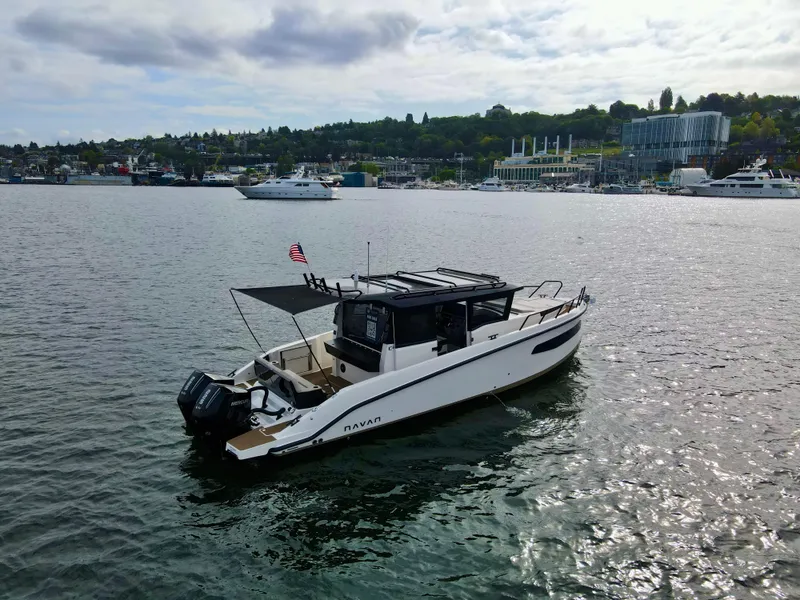 Slide: The Image of 2025 Navan C30 boat on a calm lake with scenic shoreline in the background. - 5