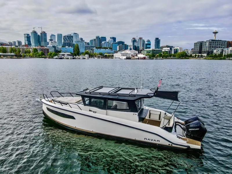 Slide: The Image of 2025 Navan C30 boat on water with city skyline in background. - 8