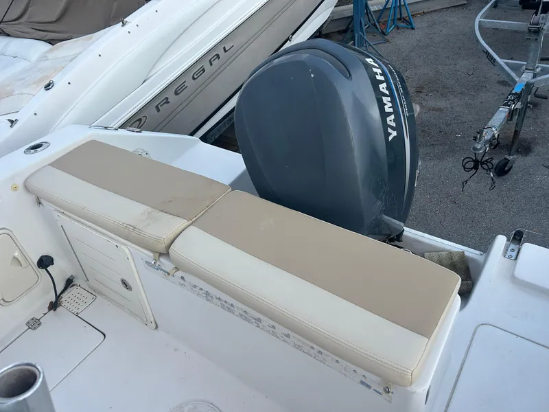 Slide: The Image of 2009 Cobia 216 Center Console boat with Yamaha outboard motor and beige seating. - 14