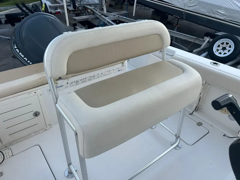 Slide: The Image of 2009 Cobia 216 Center Console boat seat with beige upholstery and metal frame. - 17