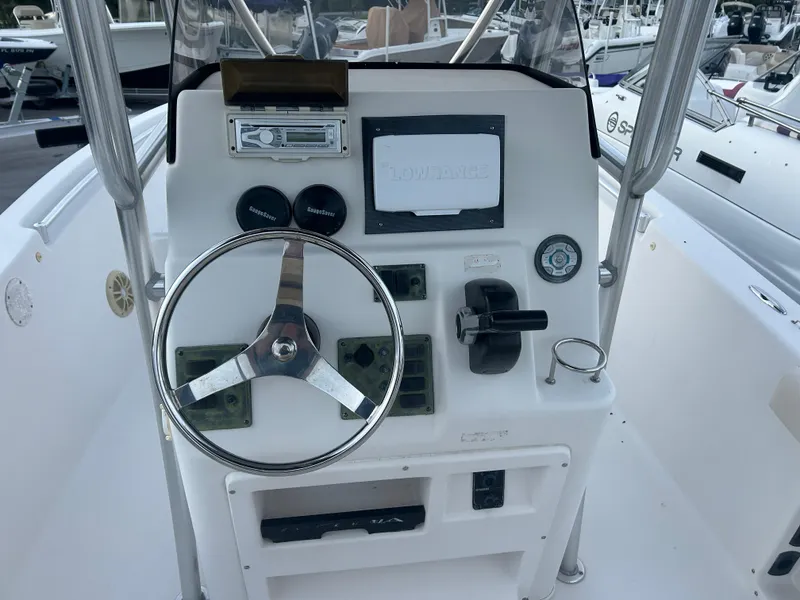 Slide: The Image of 2009 Cobia 216 Center Console boat dashboard with steering wheel and controls. - 5