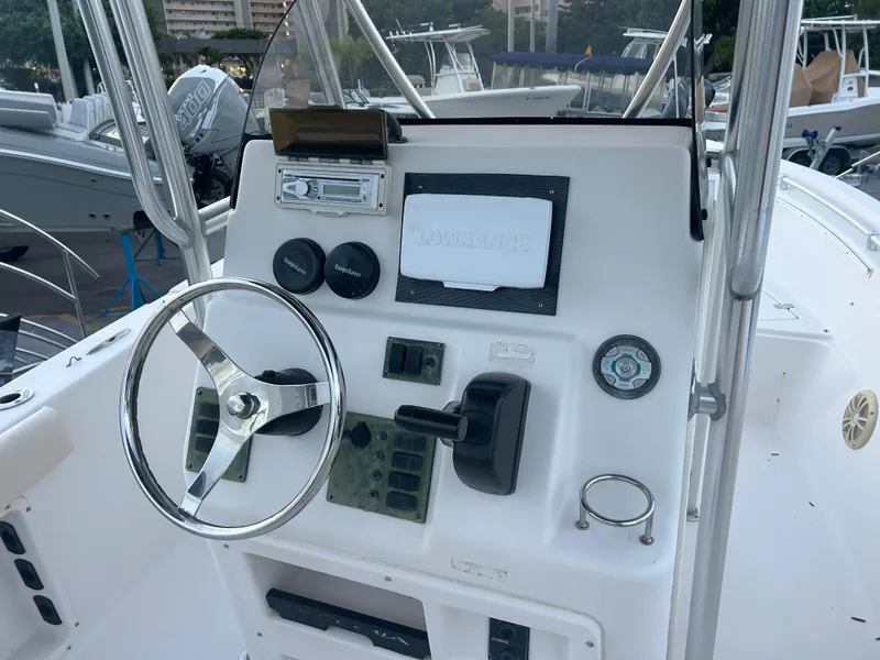 Slide: The Image of 2009 Cobia 216 Center Console boat dashboard with steering wheel and controls. - 6