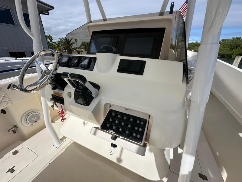 Slide: The Image of 2005 Intrepid 323 boat dashboard with steering wheel and control panel. - 13