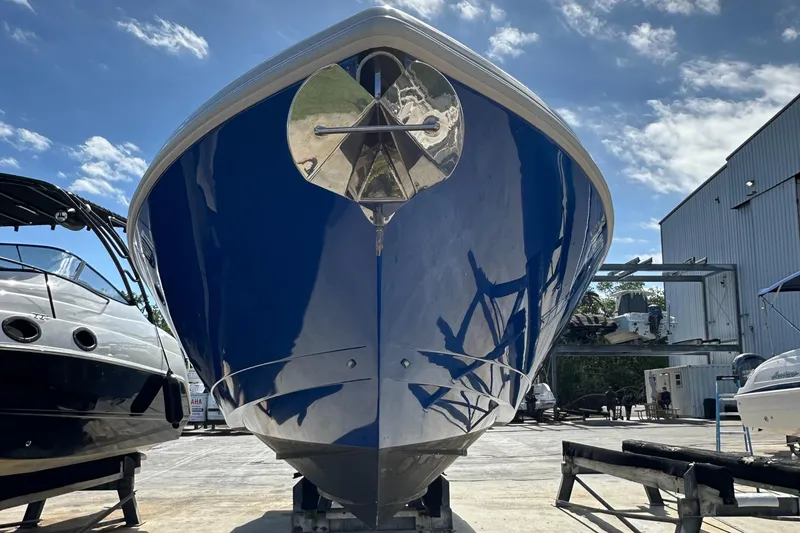 Slide: The Image of 2005 Intrepid 323 boat on dry dock under clear sky. - 16